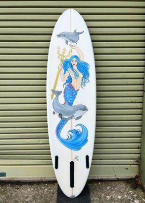ocean magic midlength surfboard with custom mermaid art by Marina Beling